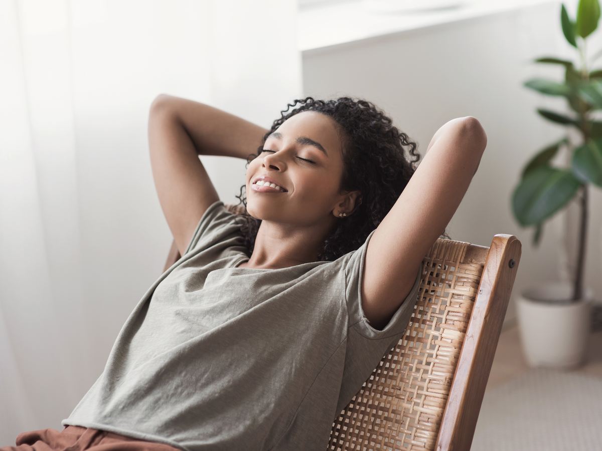 Woman leaning back in a chair, relaxed at home