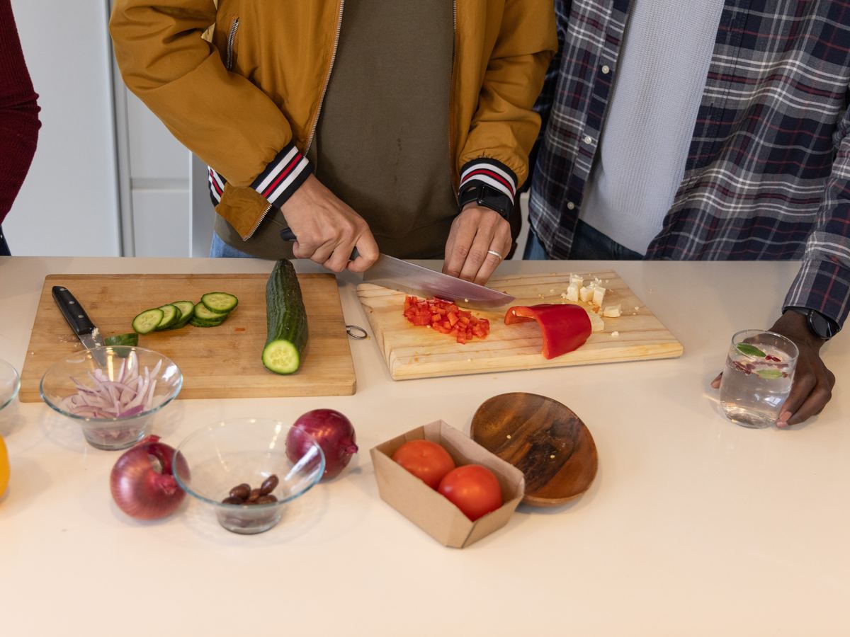 Housemates cooking together at the kitchen counter